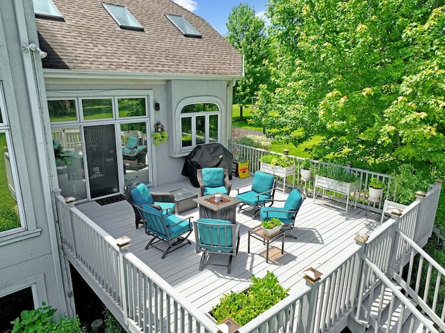 wooden deck featuring a grill and an outdoor fire pit