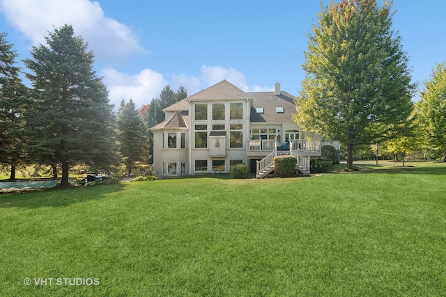 rear view of house featuring a lawn