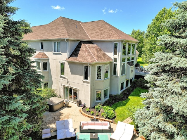 back of house with an outdoor hangout area and a patio