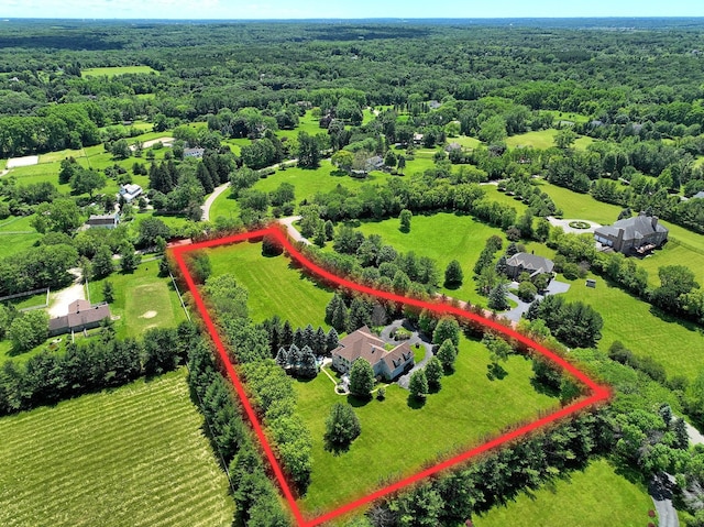 birds eye view of property with a rural view