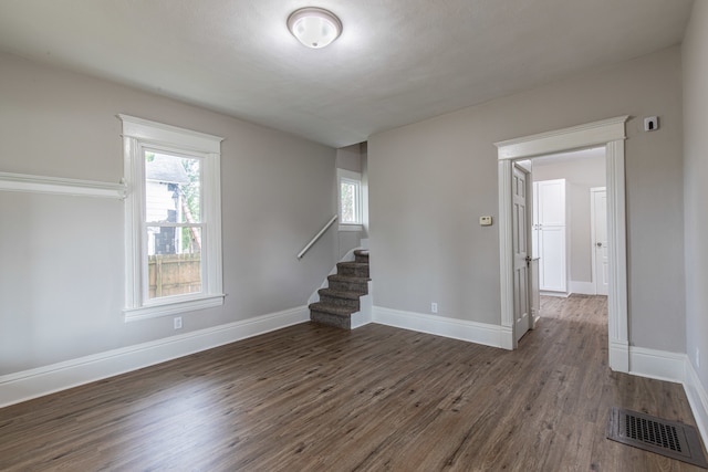 unfurnished room with dark hardwood / wood-style floors