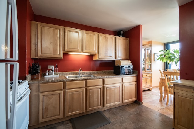 kitchen with white electric range, sink, and dark tile patterned floors