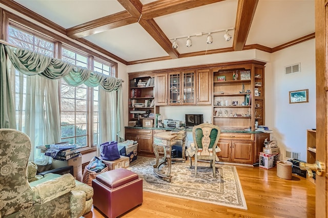 office space featuring light hardwood / wood-style floors, beam ceiling, coffered ceiling, rail lighting, and ornamental molding