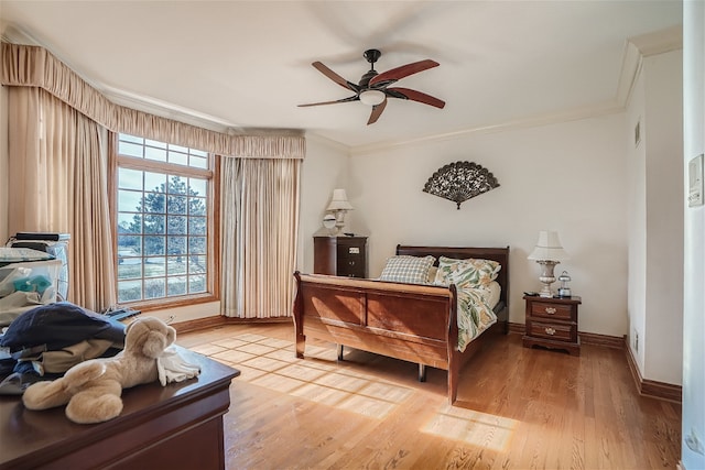 bedroom with ornamental molding, ceiling fan, and hardwood / wood-style floors