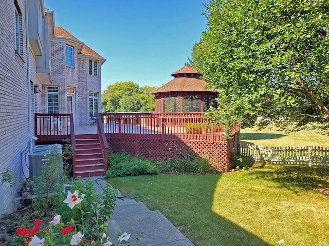 view of yard with a gazebo, a deck, and central AC