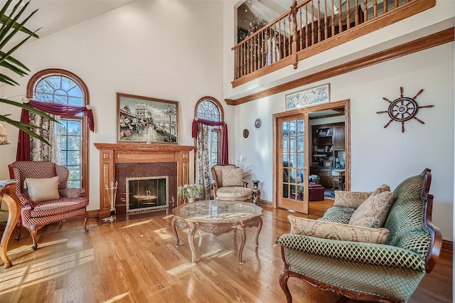 36625 N Kimberwick Ln, Wadsworth, IL 60083 - living area featuring a high ceiling, wood finished floors, a fireplace with flush hearth, and french doors