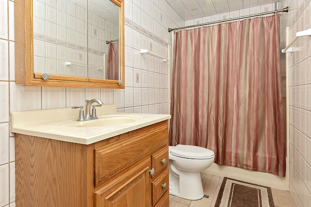 full bathroom featuring vanity, shower / tub combo, tile patterned floors, tile walls, and toilet