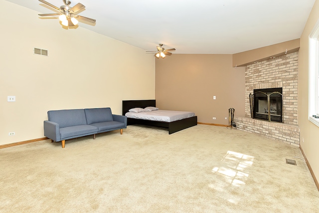 carpeted living room with a brick fireplace, vaulted ceiling, and ceiling fan