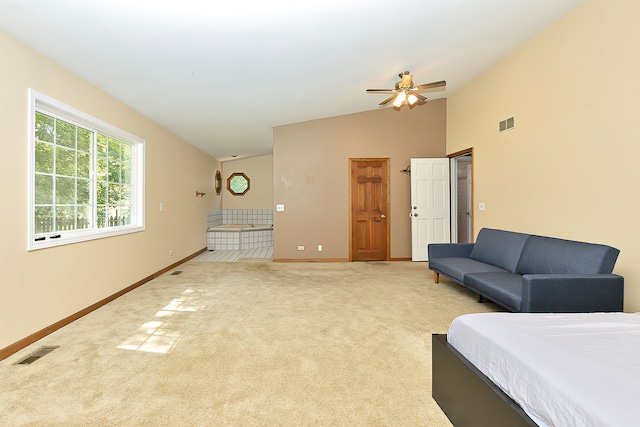 bedroom with vaulted ceiling, ceiling fan, and light carpet