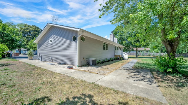 view of side of property featuring central AC