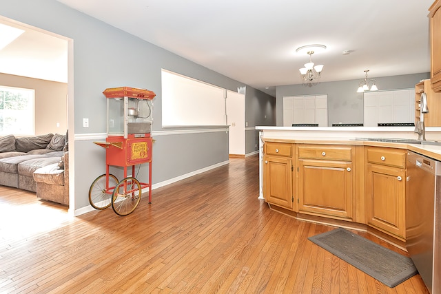 kitchen with sink, decorative light fixtures, a chandelier, dishwasher, and light wood-type flooring