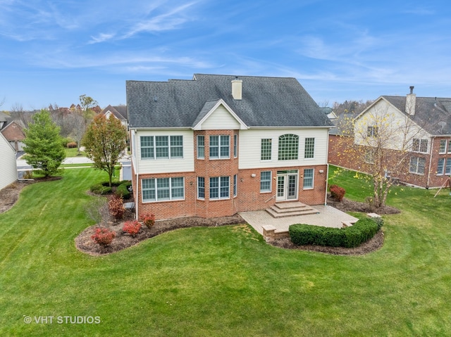 rear view of property featuring a patio area, a yard, and french doors