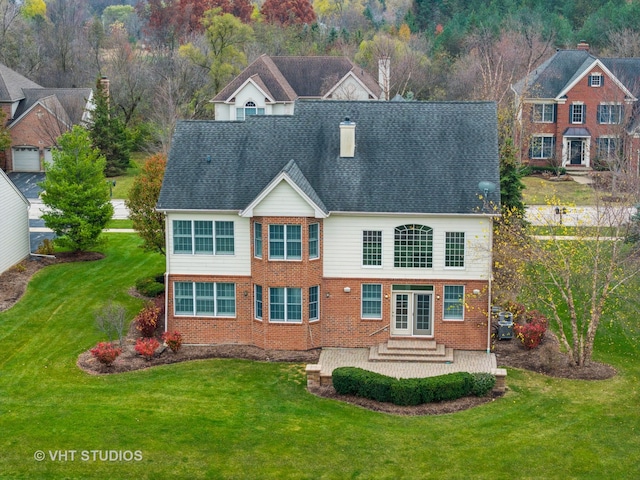 rear view of property with a patio area and a lawn