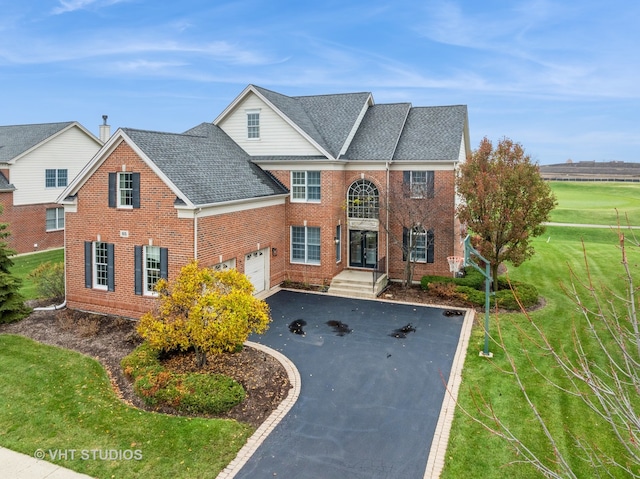 view of front of home featuring a garage and a front lawn