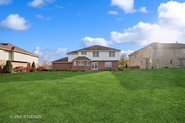 rear view of house with a yard