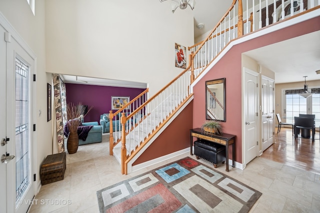 foyer entrance with a towering ceiling