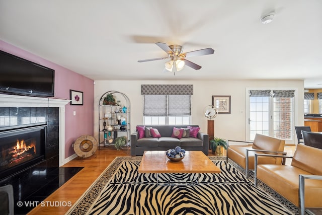 living room featuring hardwood / wood-style floors and ceiling fan