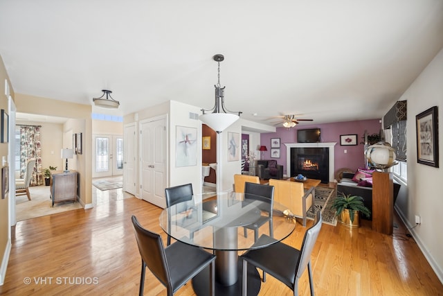 dining area featuring light hardwood / wood-style flooring, plenty of natural light, and ceiling fan