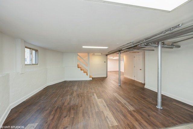 basement with dark hardwood / wood-style flooring