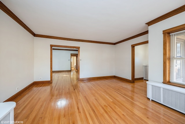 unfurnished room featuring crown molding, radiator heating unit, and light hardwood / wood-style floors