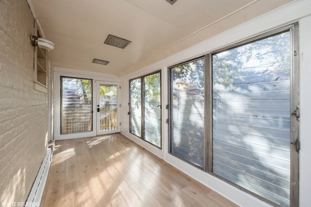 unfurnished sunroom featuring baseboard heating