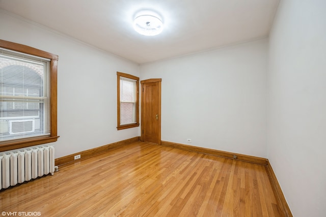 spare room with light hardwood / wood-style flooring and radiator