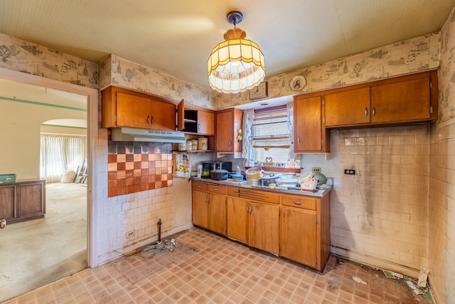 kitchen with light colored carpet and hanging light fixtures