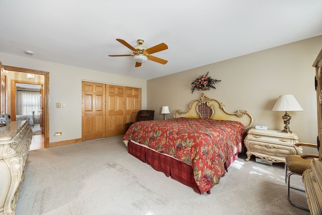 carpeted bedroom with ceiling fan and a closet