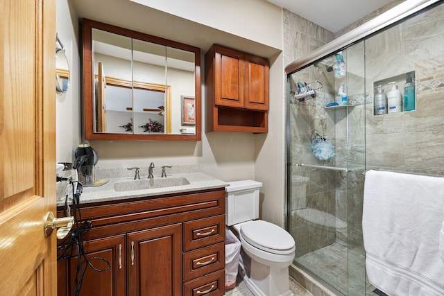 bathroom with vanity, an enclosed shower, and toilet