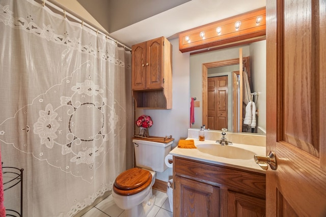 bathroom with tile patterned floors, vanity, and toilet