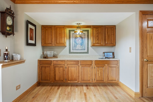 kitchen featuring pendant lighting and light hardwood / wood-style flooring