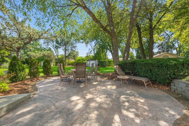 view of patio / terrace featuring a storage unit