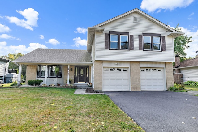 view of front of home with a front lawn and a garage