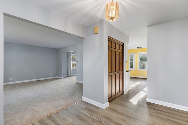 hall with light hardwood / wood-style flooring