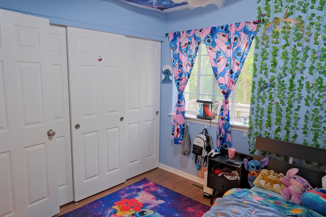 bedroom with a closet and hardwood / wood-style flooring