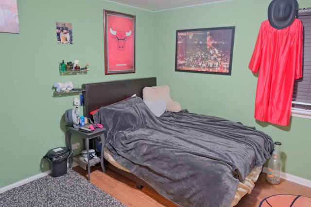 bedroom with hardwood / wood-style flooring