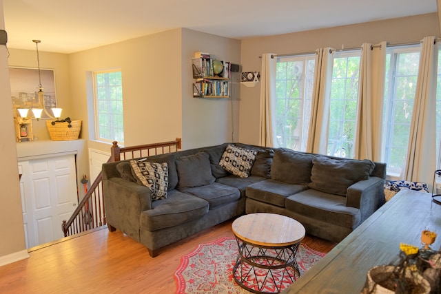 living room featuring wood-type flooring and a chandelier