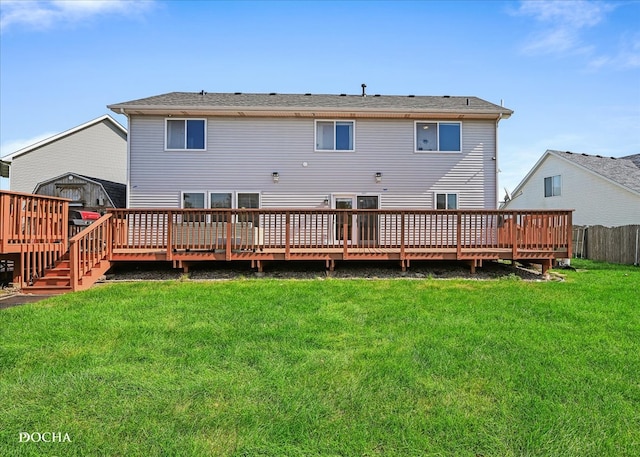 rear view of property with a deck and a lawn