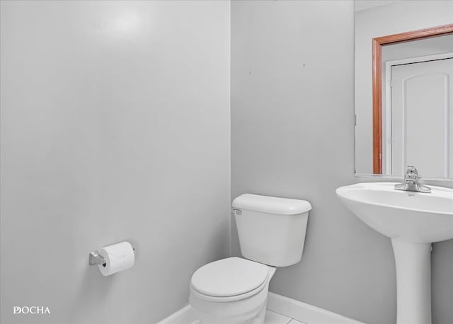 bathroom with tile patterned floors and toilet