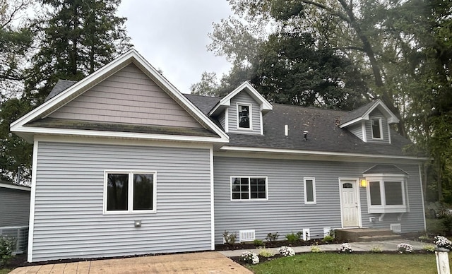 back of property featuring central AC unit