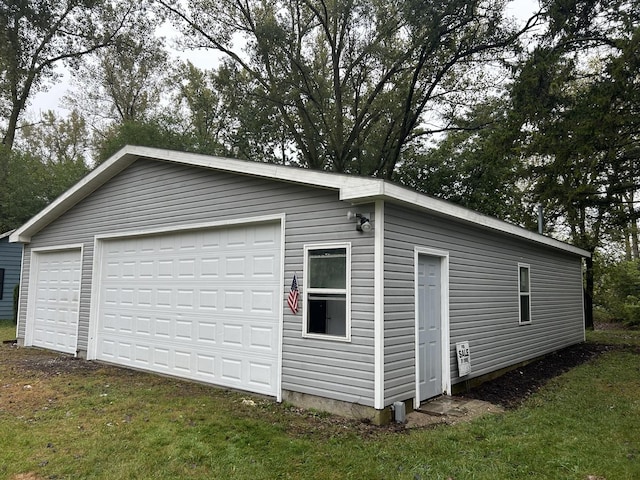 garage featuring a lawn