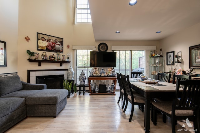 dining room featuring a fireplace and light hardwood / wood-style floors