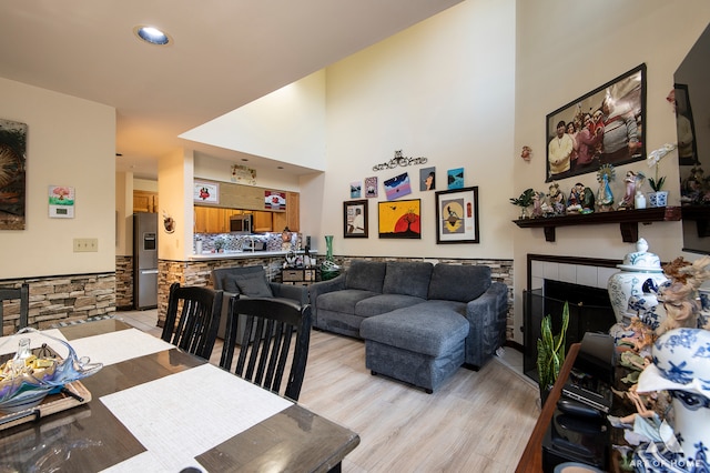 dining area featuring light hardwood / wood-style flooring and a fireplace