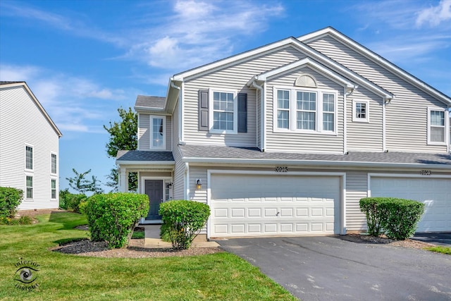 view of front of house featuring a front yard and a garage