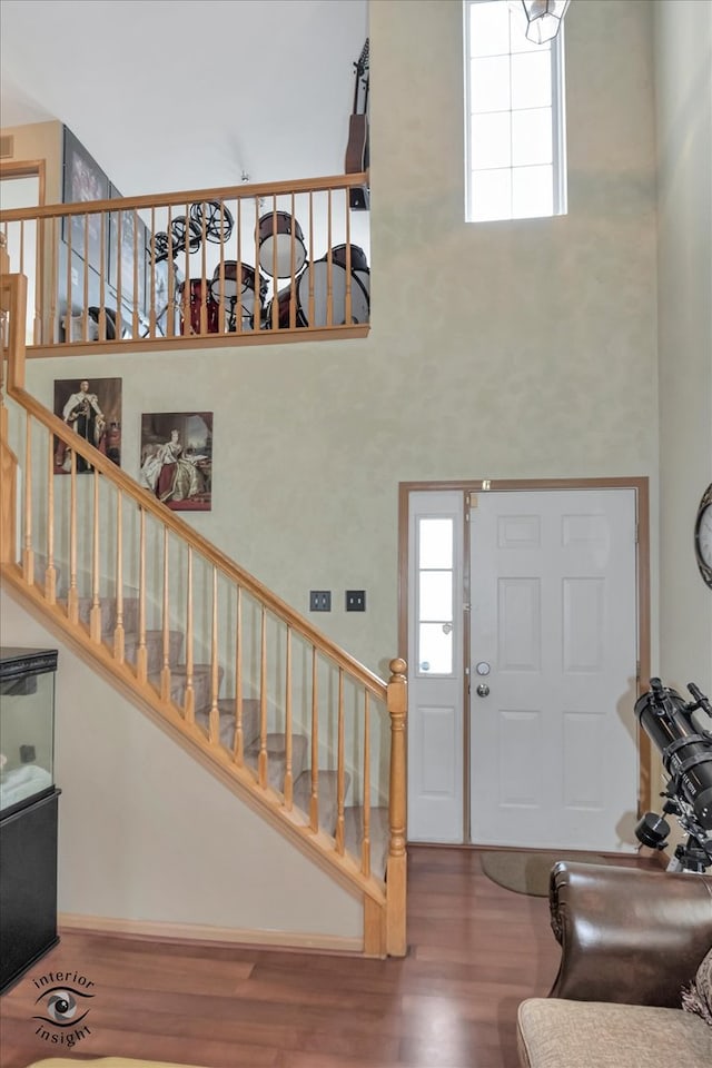 entryway with a high ceiling and hardwood / wood-style floors