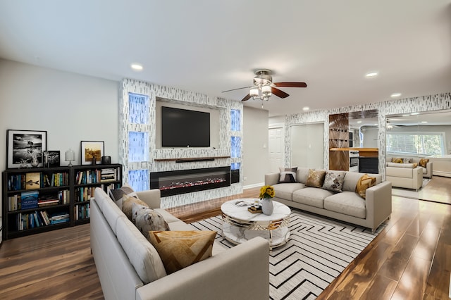 living room featuring ceiling fan and hardwood / wood-style floors