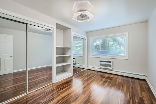 unfurnished bedroom with a baseboard radiator, a closet, dark hardwood / wood-style floors, and an AC wall unit