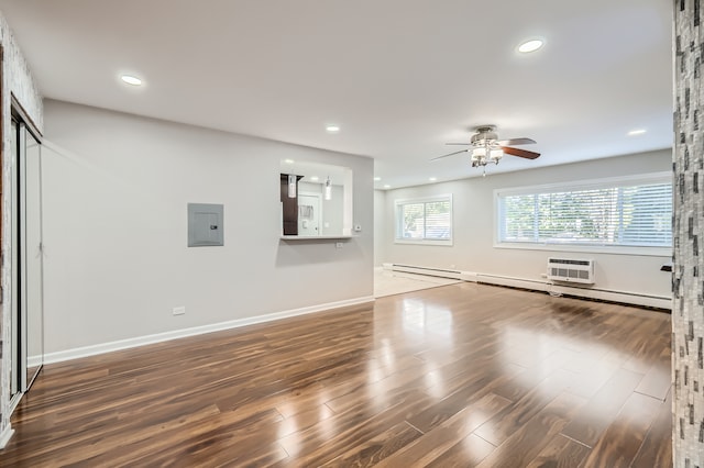 interior space featuring ceiling fan, a wall mounted air conditioner, electric panel, and dark hardwood / wood-style flooring