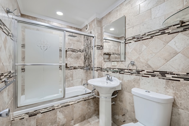 bathroom with enclosed tub / shower combo, tile walls, and crown molding