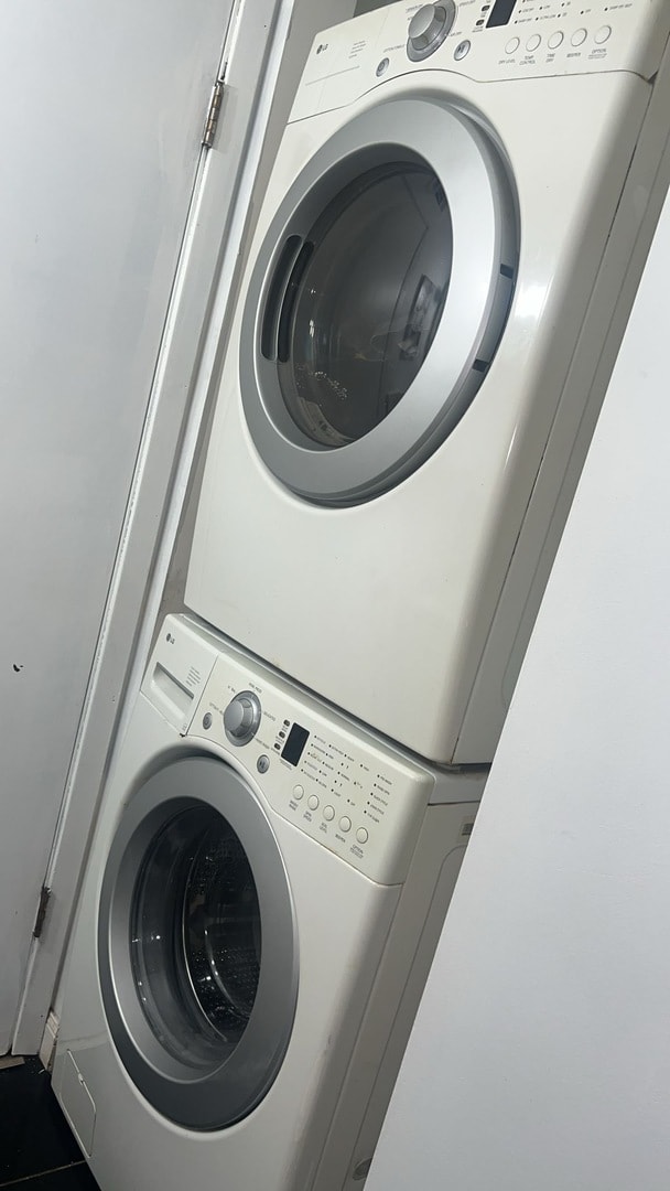 laundry room featuring stacked washer and clothes dryer